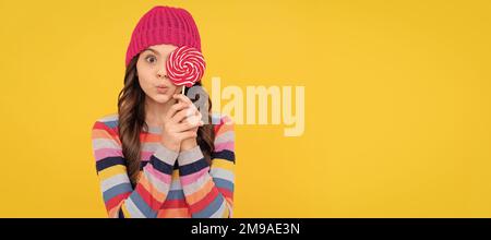 surprised teen girl hold lollipop. lollipop lady. hipster kid with colorful lollypop sugar candy. Teenager child with sweets, poster banner header Stock Photo