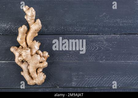 Fresh ginger roots on dark wooden background Stock Photo