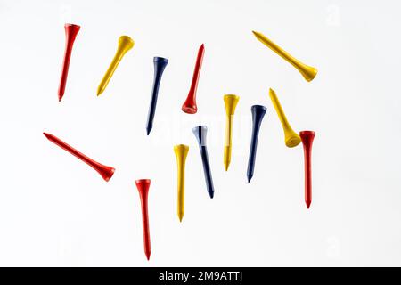 color wooden bamboo golf tees fallnig through the air isolated on a wooden background Stock Photo