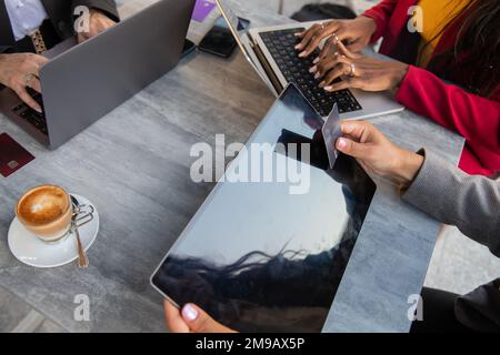 Three women shop online, female friends spend money with credit cards on the internet Stock Photo