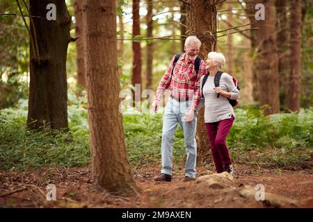 Loving Retired Senior Couple Hiking In Woodland Countryside Together Stock Photo