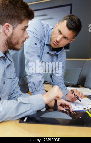 two men in the office with checklist Stock Photo