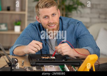 repairman working in technical support fixing computer Stock Photo