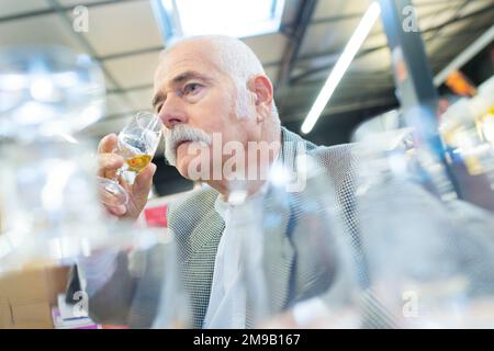 senior gentleman standing with glass Stock Photo