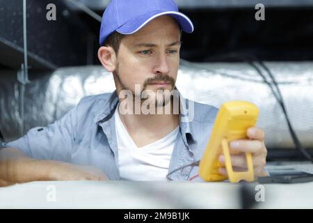 electrician checking the reading of a meter Stock Photo