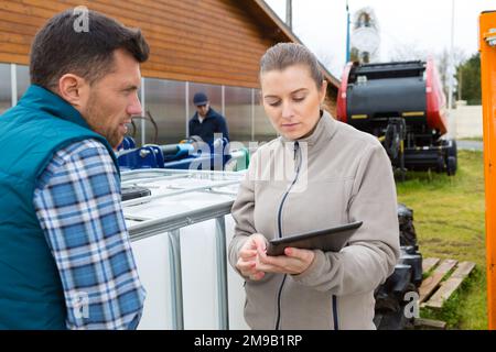 agricultural workers checking using digital tablet Stock Photo