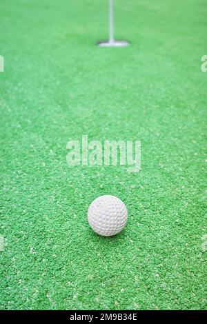 Close up picture of a golf ball at a mini golf course, selective focus. Stock Photo