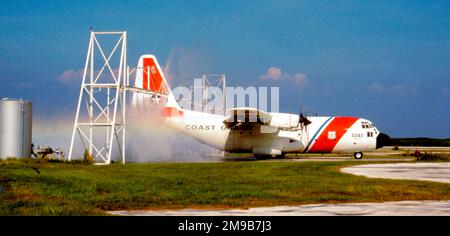 United States Coast Guard - Lockheed HC-130B Hercules 1341 'Clearwater' (msn 282-3542, ex USAF 58-6973), taxiing through the freshwater spray rig at Clearwater Coast Guard Air Station, to remove salt-spray deposits. Stock Photo