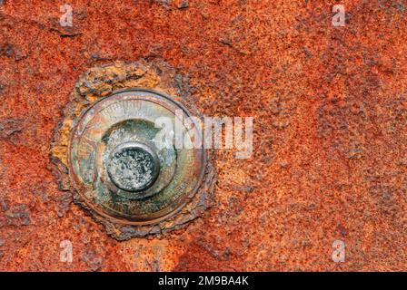 Rusted combination lock on a red rusty safe door Stock Photo