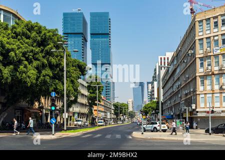 People walking in the city center with old buildings and modern skyscrapers in Tel Aviv, Israel. Stock Photo