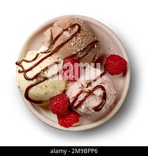 plate of various ice cream balls decorated with chocolate sauce and fresh rasberries isolated on white background, top view Stock Photo