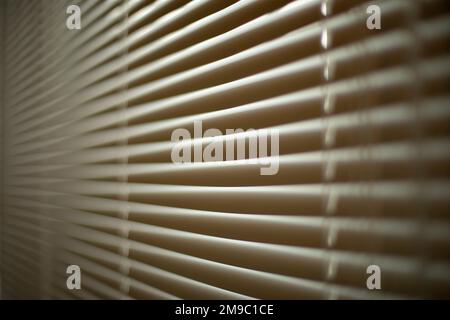 Blinds in office. Interior details. Window is closed from light. Protection from spicy sunlight. Blinds on window. Stock Photo