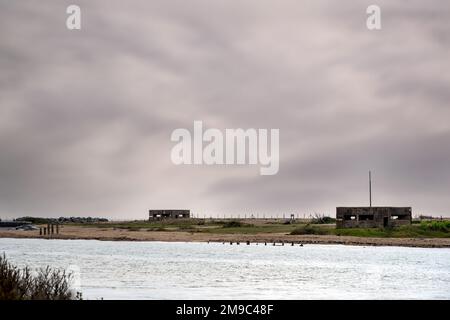 Pillboxes on Rye Harbour shingle beach, East Sussex, England Stock Photo