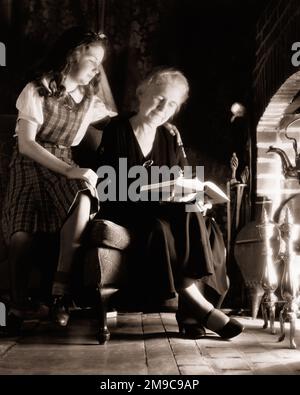 Two teen girls sitting by fireplace, wearing tights and slippers