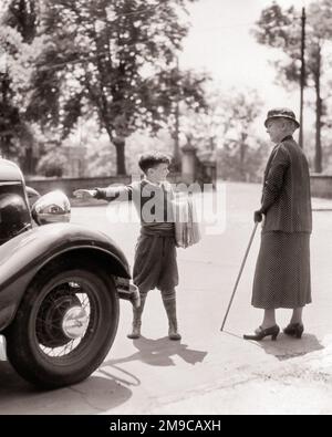 1930s YOUNG NEWSPAPER BOY IN KNEE BRITCHES ON STREET CORNER SELLING ...