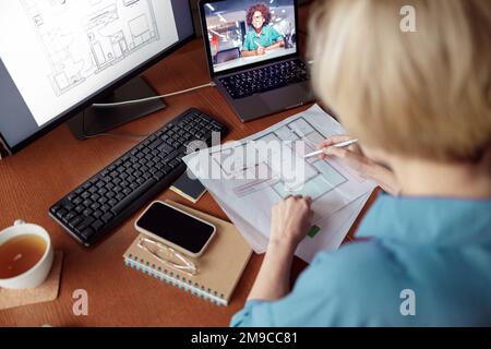 Woman engineer construction is developing construction project documentation sitting at home office Stock Photo