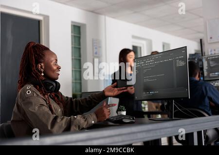 Smiling software developer programming server code algorithm on computer, typing sever data in big data office. Database engineer working on new user interface with online system to create algorithm. Stock Photo