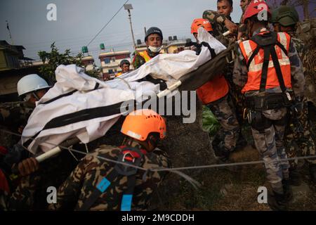 Nepal army, Police, AFP Rescuers search for the body of a victim who ...