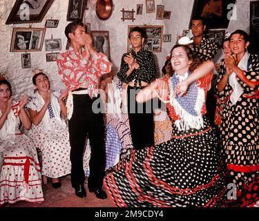 1940s 1950s PEOPLE DANCING FLAMENCO CLAPPING AND SINGING INSIDE ONE OF THE GYPSY CAVE HOMES OF SACROMONTE IN GRANADA SPAIN - kr8470 LAN001 HARS SATISFACTION CELEBRATION FEMALES CLAPPING RURAL HOME LIFE COPY SPACE FRIENDSHIP FULL-LENGTH HALF-LENGTH LADIES PERSONS INSPIRATION TRADITIONAL MALES ENTERTAINMENT CONFIDENCE EUROPE SPAIN PERFORMING ARTS GYPSY HAPPINESS EUROPEAN AND EXCITEMENT RECREATION SONG TRADITION VOCAL PRIDE CAVE ENTERTAINER HOMES MOTION BLUR VOCALIZE POLKA DOT VOCALS CULTURE ESTABLISHED SONGS STYLISH WHITEWASHED COOPERATION JOYOUS YOUNG ADULT MAN YOUNG ADULT WOMAN OLD FASHIONED Stock Photo