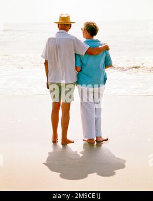 1970s SENIOR COUPLE WALKING BAREFOOT ON THE BEACH THROUGH THE SURF MAN WEARING HAT SHORTS HAS ARM AROUND WOMAN’S SHOULDERS - ks11660 HAR001 HARS RETIRED ATLANTIC SHORTS STYLE COMMUNICATION YOUNG ADULT PEACE VACATION JOY LIFESTYLE OCEAN SATISFACTION ELDER FEMALES MARRIED SPOUSE HUSBANDS HOME LIFE COPY SPACE FRIENDSHIP FULL-LENGTH LADIES PERSONS CARING MALES RETIREMENT SURF CONFIDENCE SENIOR MAN SENIOR ADULT PARTNER WOMAN'S SENIOR WOMAN FREEDOM TIME OFF SHORE RETIREE DREAMS HAPPINESS OLD AGE OLDSTERS HIGH ANGLE OLDSTER ADVENTURE LEISURE TRIP GETAWAY RECREATION REAR VIEW BAREFOOT BEACHES HOLIDAYS Stock Photo
