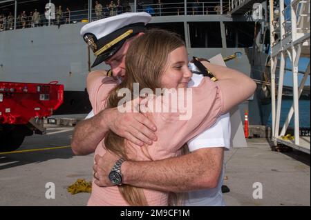 APRA HARBOR, Guam (May 16, 2022) – Lt. Brandon Shellenberger, assigned to the Emory S. Land-class submarine tender USS Frank Cable (AS 40), hugs his daughter after returning from patrol, May 16, 2022. Frank Cable has returned from conducting expeditionary maintenance and logistics in support of national security in the U.S. 7th Fleet area of operations. Stock Photo