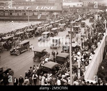 1920s LARGE DIVERSE CROWD OF PEDESTRIANS ON CROWDED SIDEWALKS AND ROAD OF A BRIDGE CARS PARKED AND ALSO MOVING TRAFFIC - m6786 CPC001 HARS BUSY NOSTALGIA MOVING OLD FASHION AUTO JUVENILE DIVERSE VEHICLE FLAGS RAILROAD JOY CELEBRATION CROWDS FEMALES ASSEMBLY LADIES MASS PERSONS AUTOMOBILE CUTOUT MALES PEDESTRIANS TRANSPORTATION SPECTATORS B&W GATHERING PARKED RAIL HIGH ANGLE AFRICAN-AMERICANS AFRICAN-AMERICAN AND AUTOS EXCITEMENT BLACK ETHNICITY CONNECTION SIDEWALKS AUTOMOBILES STARS AND STRIPES VARIOUS VEHICLES RAILROADS OLD GLORY VARIED COOPERATION HOLDAY RED WHITE AND BLUE SPAN THRONG Stock Photo