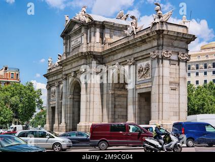 Madrid, Spain - May 2018: The Puerta de Alcala is a Neo-classical monument in the Plaza de la Independencia with traffic jam Stock Photo