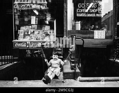 Young Girl Swinging in front of Go Sing Coffee Shop, Chinatown, New York City, New York, USA, Angelo Rizzuto, Anthony Angel Collection, September 1958 Stock Photo