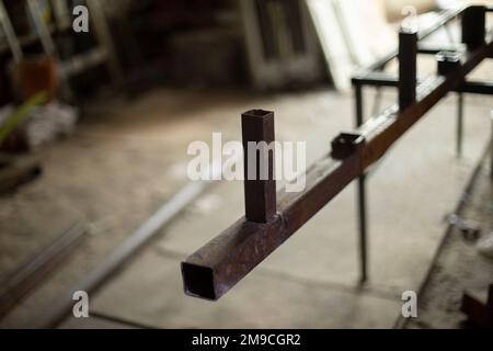 Metal processing in garage. Steel billet in garage. Stock Photo