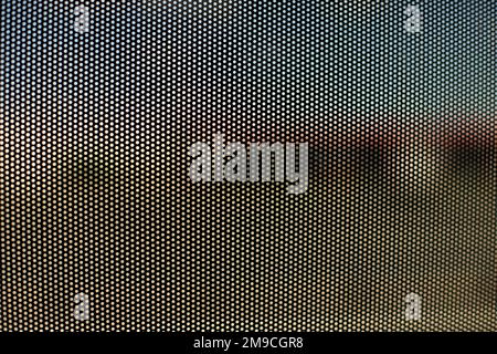 Mesh texture on glass. Shooting window. Small cage. Stock Photo