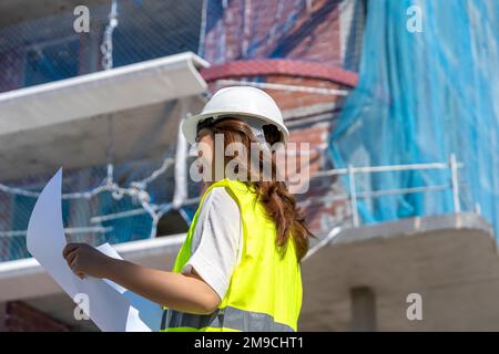 female architect checking construction plans Stock Photo