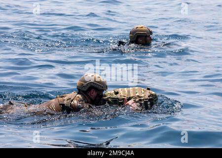 220516-N-PC065-1146   SKYROS ISLAND, Greece (May 16, 2022) – U.S. Marines attached to the 22nd Marine Expeditionary Unit, deployed with the San Antonio-class amphibious transport dock ship USS Arlington (LPD 24), swim to a combat rubber raiding craft during joint training with Hellenic Armed Forces off the coast of Skyros Island, Greece, May 16, 2022. Arlington, with embarked 22nd Marine Expeditionary Unit, is participating in exercise Alexander the Great 2022 under the command and control of Task Force 61/2. Alexander the Great 22 strengthens interoperability and force readiness between the U Stock Photo