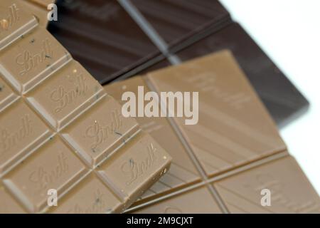 KYIV, UKRAINE - MAY 4, 2022 Lindt Swiss luxury brand chocolate brown tablets with embossed original company logo. Stock Photo