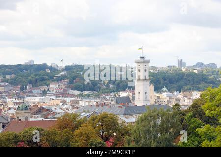 LVIV, UKRAINE - SEPTEMBER 11, 2022 Panorama view of the historical old city in Lviv, Ukraine. Many old buildings with metal roofs and cathedral domes in beginning of autumn day Stock Photo