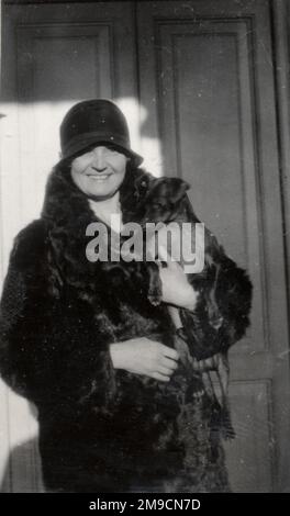 A woman wearing a fur coat and a cloche hat. Stock Photo