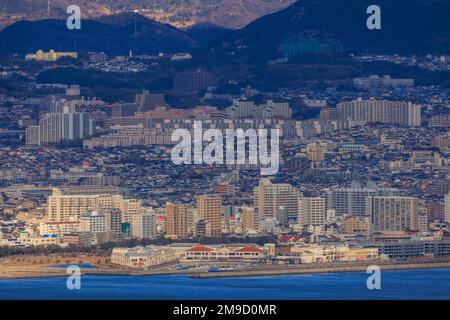 Tarumi, Japan - January 16, 2023: Multi-story residential apartments in sprawling hillside city on coast Stock Photo