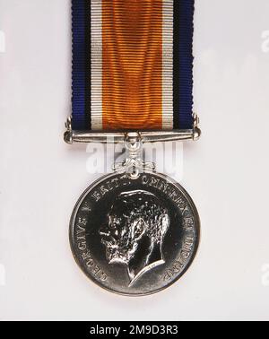 British War Medal, 1914-20. The silver medal, by W McMillan, commemorates the service rendered by the Allies who were actively engaged in World War I. The obverse shows the coinage effigy of George V; the reverse, a figure on horseback trampling upon the shield of the Central Powers. A skull and crossbones symbolises death; the risen sun, victory. The recipient's name and service details are inscribed around the edge. Stock Photo