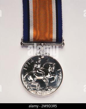 British War Medal, 1914-20. The silver medal, by W McMillan, commemorates the service rendered by the Allies who were actively engaged in World War I. The obverse shows the coinage effigy of George V; the reverse, a figure on horseback trampling upon the shield of the Central Powers. A skull and crossbones symbolises death; the risen sun, victory. The recipient's name and service details are inscribed around the edge. Stock Photo