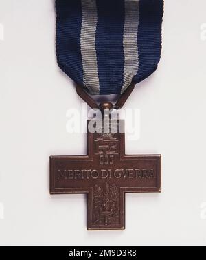 Merito di Guerra, Italian War Merit Cross, bronze medal, introduced during WWI, also awarded during WWII, featuring crest of Victor Emmanuel III (1869-1947), King of Italy, above sword and oak leaves. Stock Photo