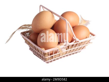 Raw chicken eggs in a basket on a white background Stock Photo