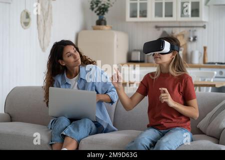 Mother limiting child use of vr technologies, teen girl spending too much time in virtual world Stock Photo