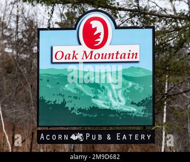 A road sign for Oak Mountain sky center and the Acorn Pub and Eatery in Speculator, NY in the Adirondack Mountains Stock Photo