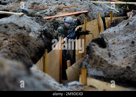 German soldiers assigned to the 212th Panzergrenadier Battalion, 21st Panzer Brigade, 1st Panzer Division, clear out a trench during a live-fire exercise as part of Defender Europe at Oberlausitz Training Area, Germany, May 17, 2022. Defender Europe 22 is a series of U.S. Army Europe and Africa multinational training exercises in Eastern Europe. The exercise demonstrates U.S. Army Europe and Africa’s ability to conduct large-scale ground combat operations across multiple theaters supporting NATO. Stock Photo