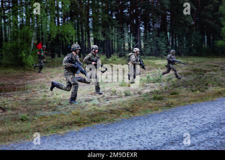 German soldiers assigned to the 212th Panzergrenadier Battalion, 21st Panzer Brigade, 1st Panzer Division, advance to their target during a live-fire exercise as part of Defender Europe at Oberlausitz Training Area, Germany, May 17, 2022. Defender Europe 22 is a series of U.S. Army Europe and Africa multinational training exercises in Eastern Europe. The exercise demonstrates U.S. Army Europe and Africa’s ability to conduct large-scale ground combat operations across multiple theaters supporting NATO. Stock Photo