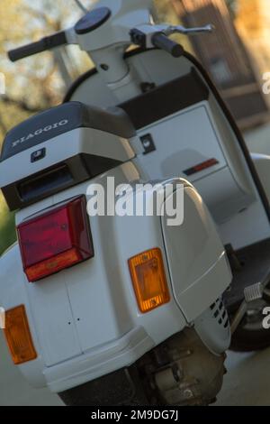 Close-up image of an old white colored Piaggio Vespa motorcycle. Firenze, Italia 01-15-2023 Stock Photo