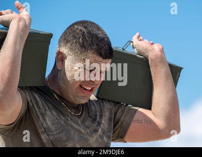 U.S. Air Force Airman 1st Class Tristen Cardoza, a defender assigned to the 6th Security Forces Squadron, performs overhead presses during the second annual Defenders Challenge for National Police Week May 17, 2022, at MacDill Beach, Florida. The challenge consisted of a blind-folded M-4 Carbine rifle assembly, a ruck march and beach crawl. Every year, MacDill Airmen come together to celebrate National Police Week by honoring military and civilian law enforcement who paid the ultimate sacrifice while in the line of duty. Stock Photo