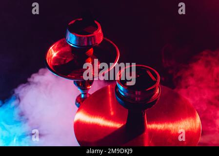 hookah bowl and coals close up on black background with smoke Stock Photo