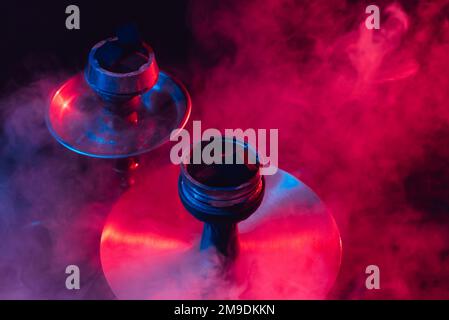 hookah bowl and coals close up on black background with smoke Stock Photo