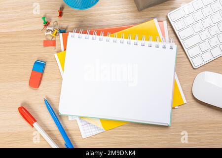 Back to school concept. Top view photo of notepads, pens, sharpeners, ruler, staplers, clips, markers and erasers on wooden table Stock Photo