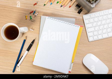 Back to school concept. Top view photo of notepads, pens, sharpeners, ruler, staplers, clips, markers and erasers on wooden table Stock Photo